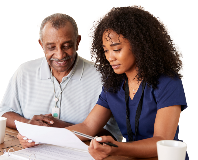 Healthcare worker helping a patient with paperwork