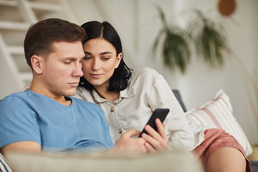 couple reading information on a smartphone