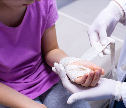 doctor bandaging a child's hand