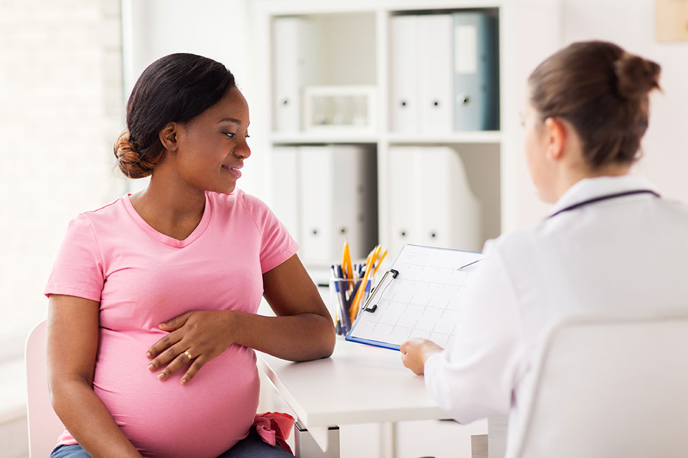 pregnant woman talking to doctor